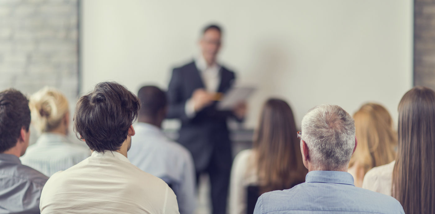 Group of people attending a speech.