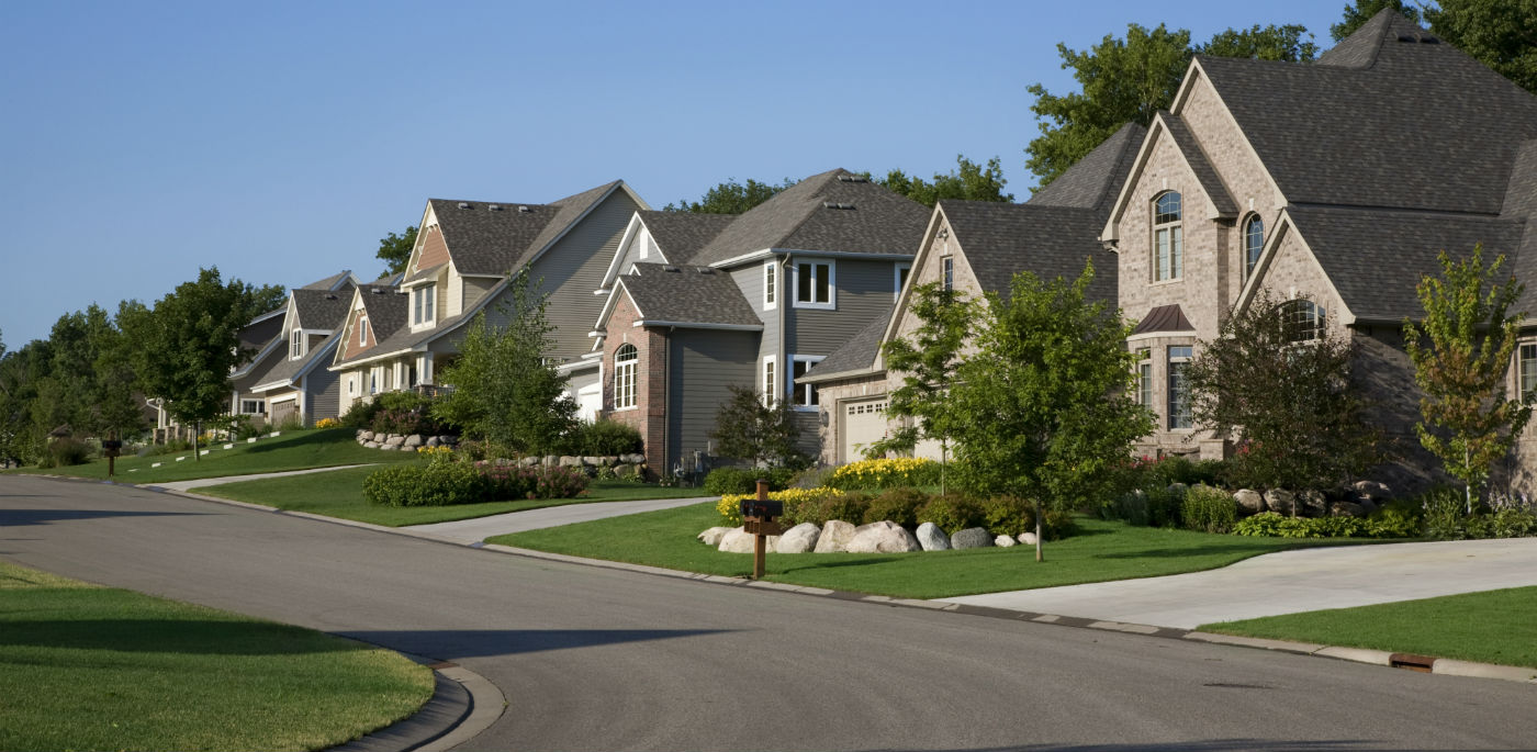 Houses line a street.