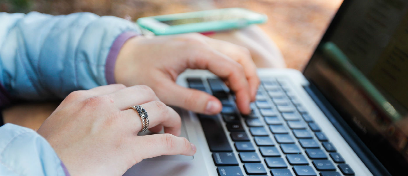 Hands on a laptop.