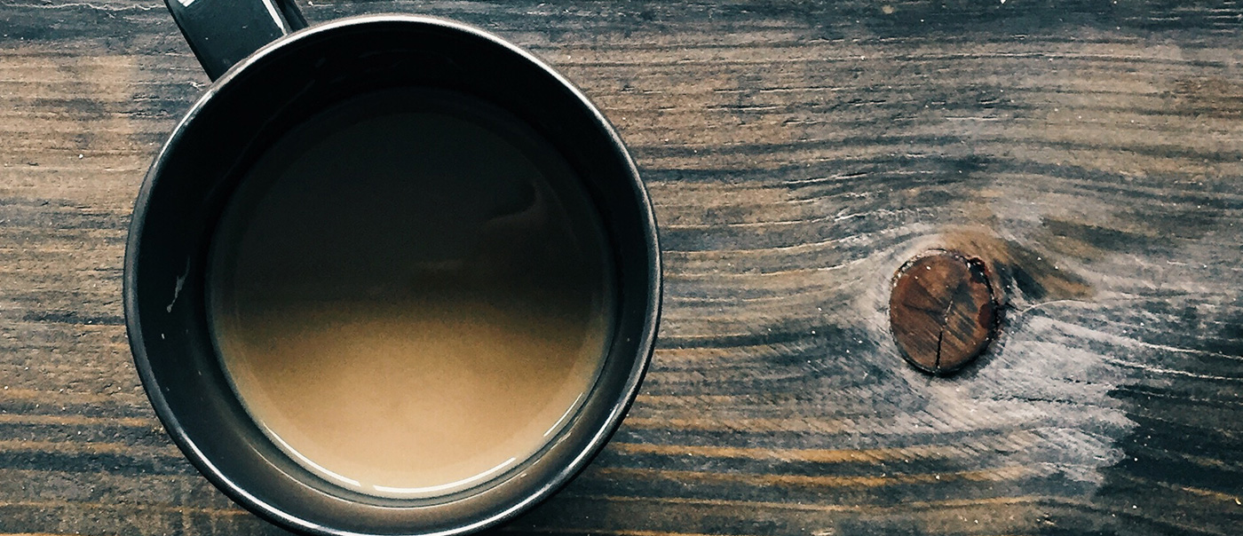 Cup of coffee on wood desk