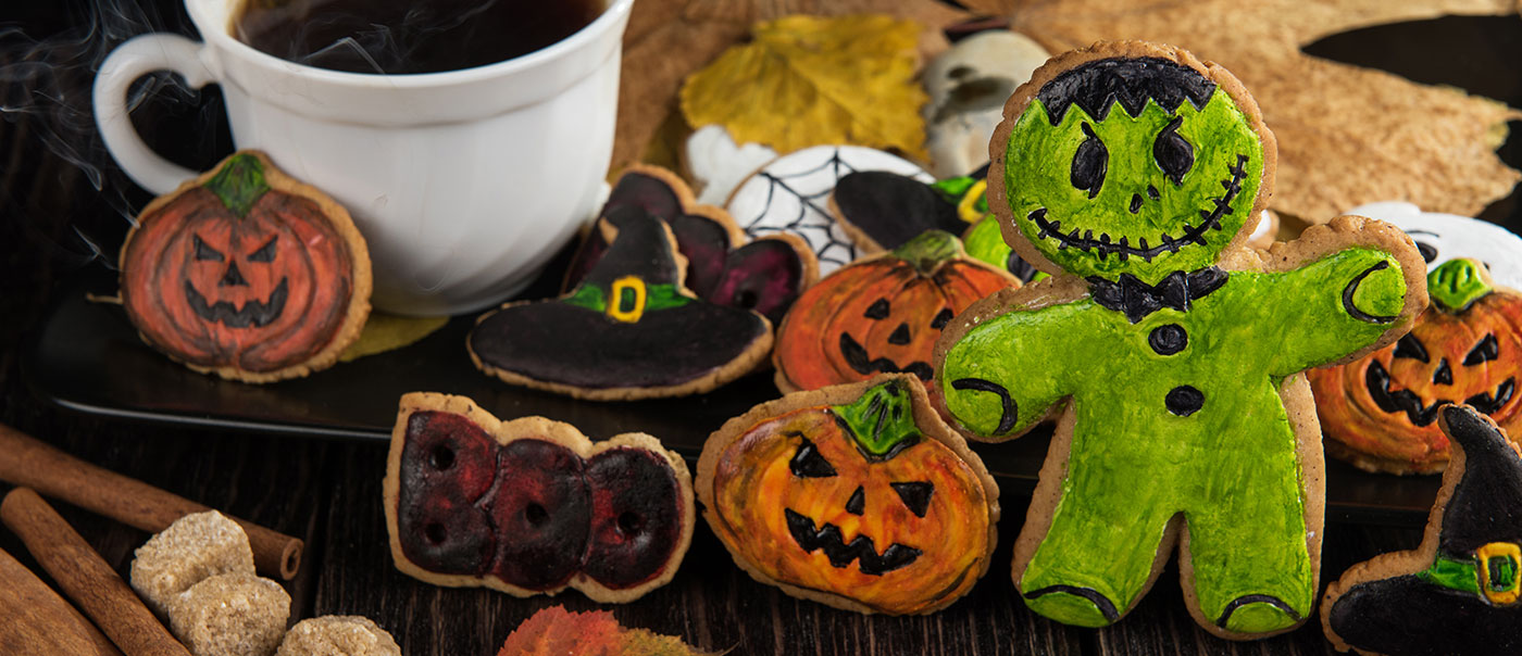 Coffee cup next to Halloween cookies