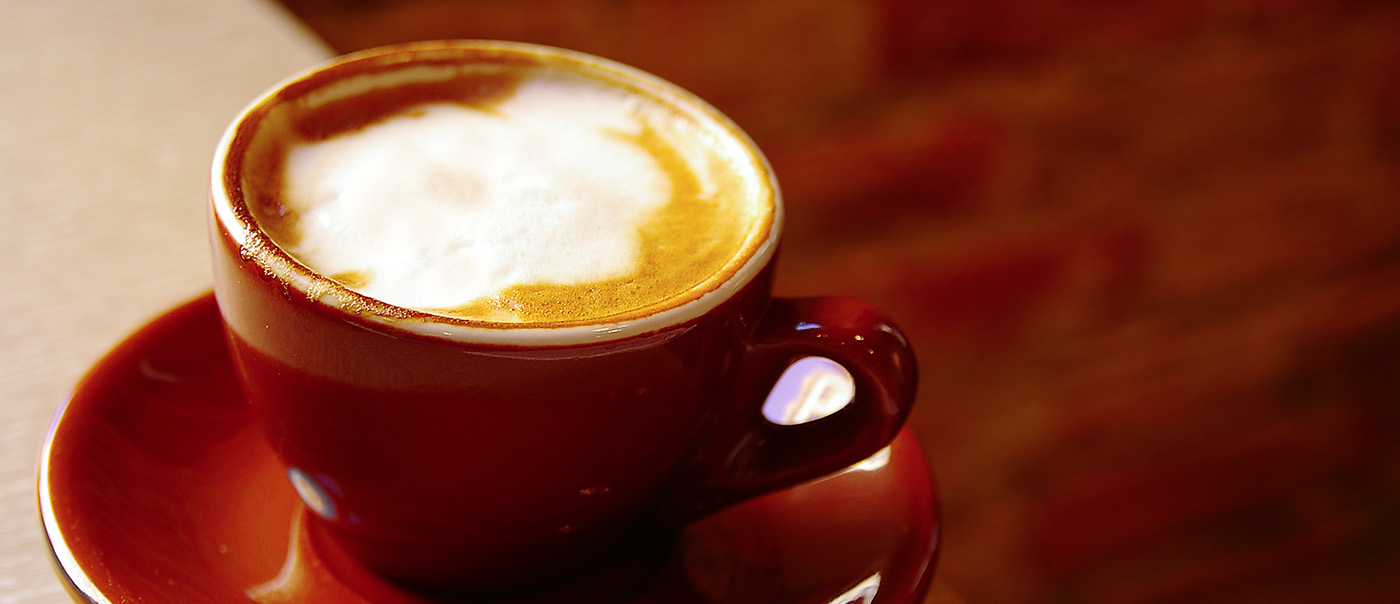 Cup of coffee sits on a table.