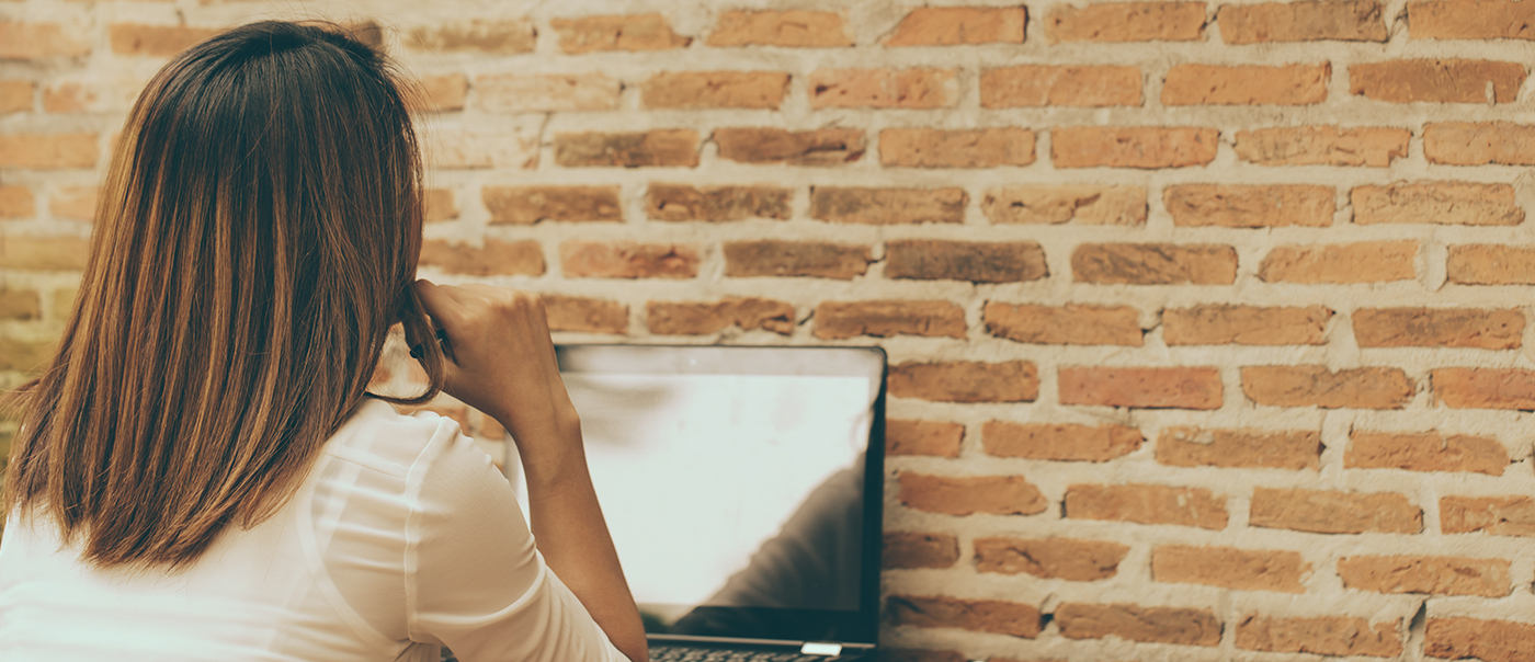 Woman stares at wall thinking of new blog ideas.