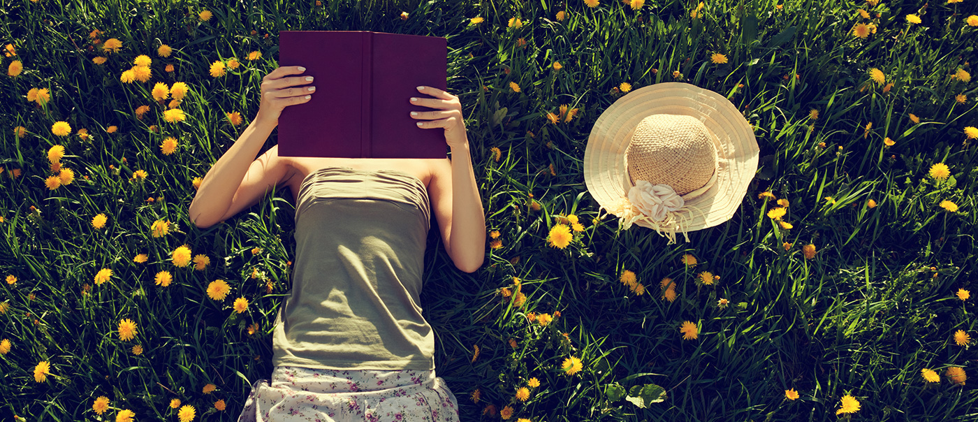 Woman reading on grass.