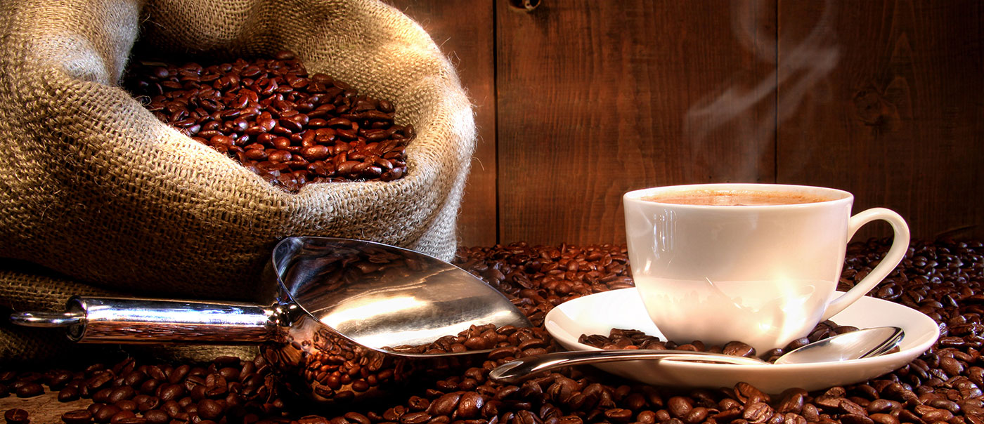 Coffee beans next to cup