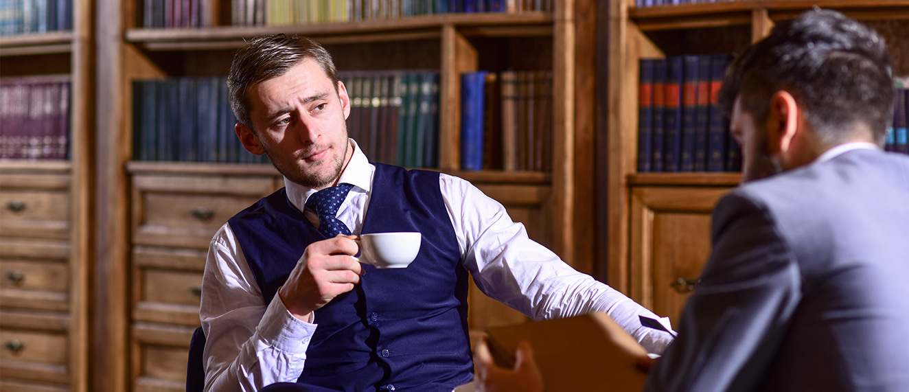 Rich college kid drinking coffee in library