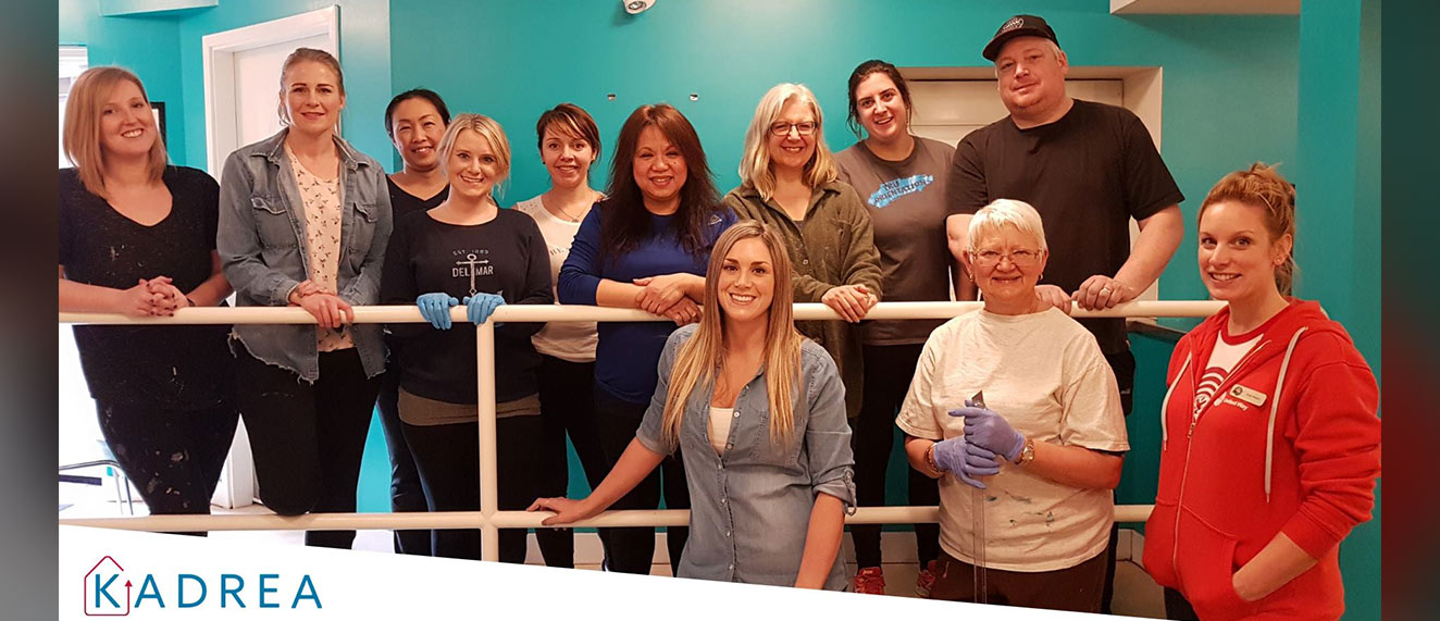 A group of volunteers painting a room