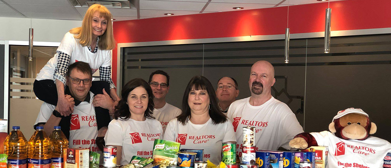 REALTORS(r) standing in front of food donations