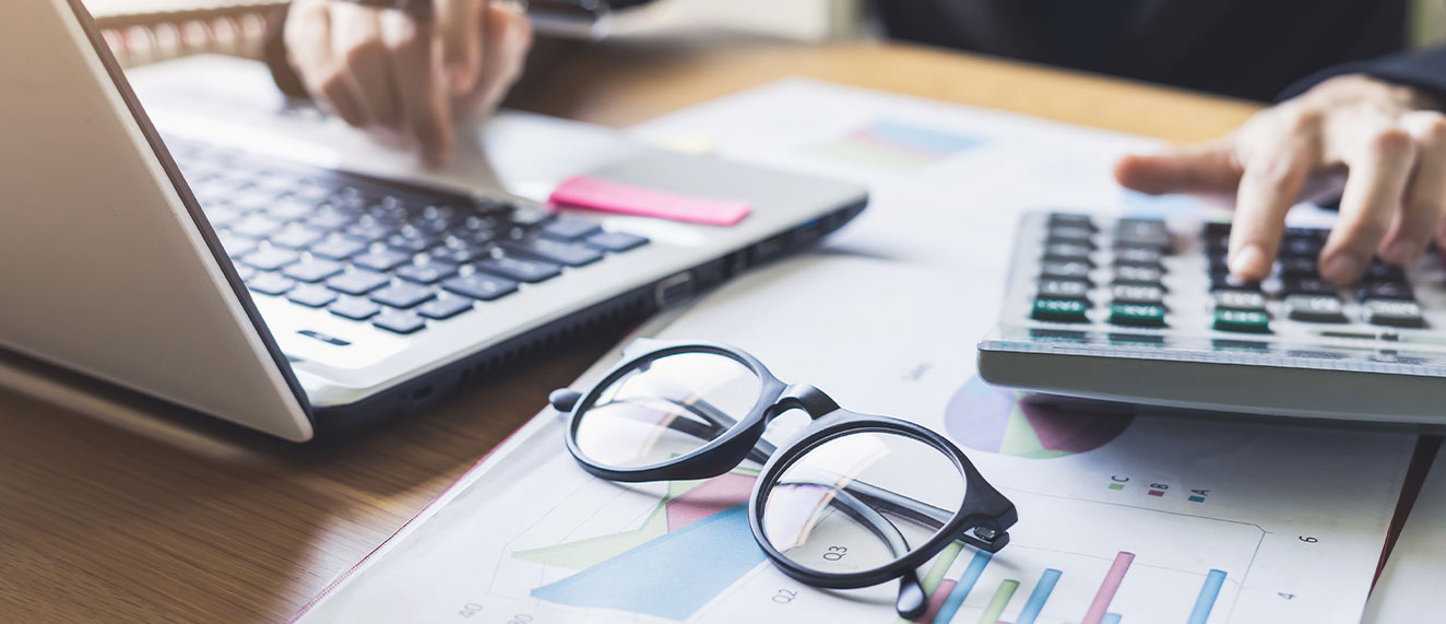 Person doing financial work at desk.