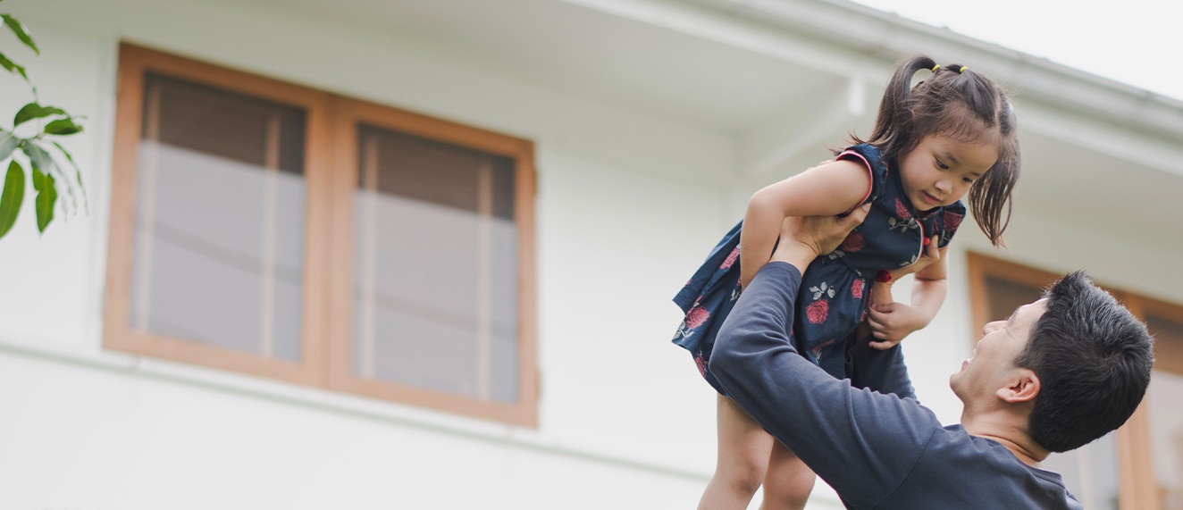 Happy family in front of new home