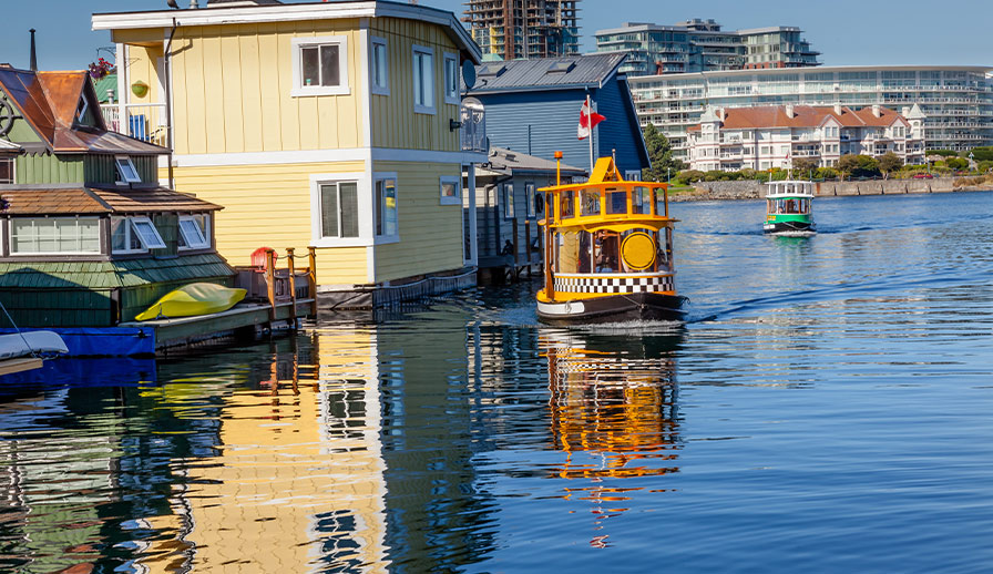 Tugboat driving by floating home. 