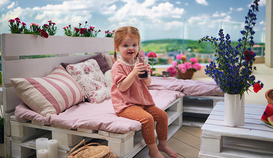 Cute kid sitting on deck.