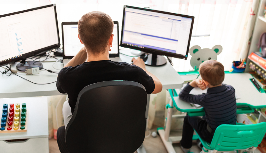 Dad working beside child