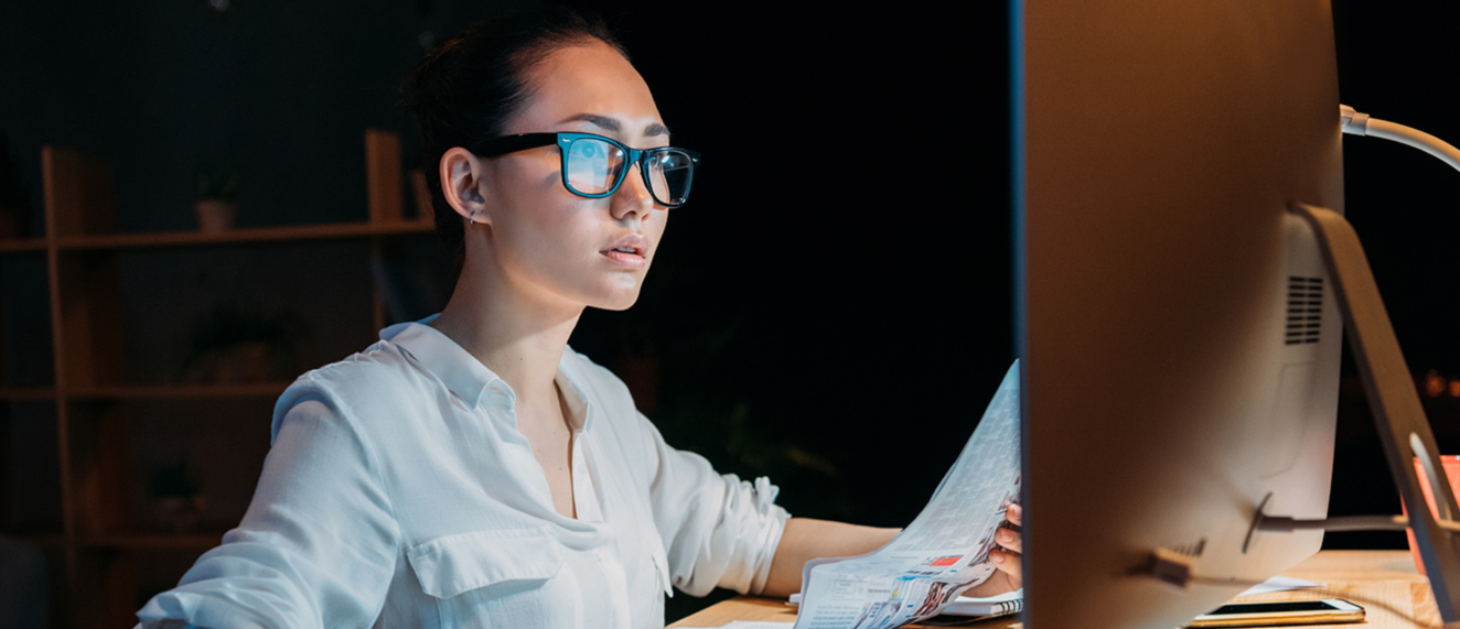 Woman completes paperwork at computer