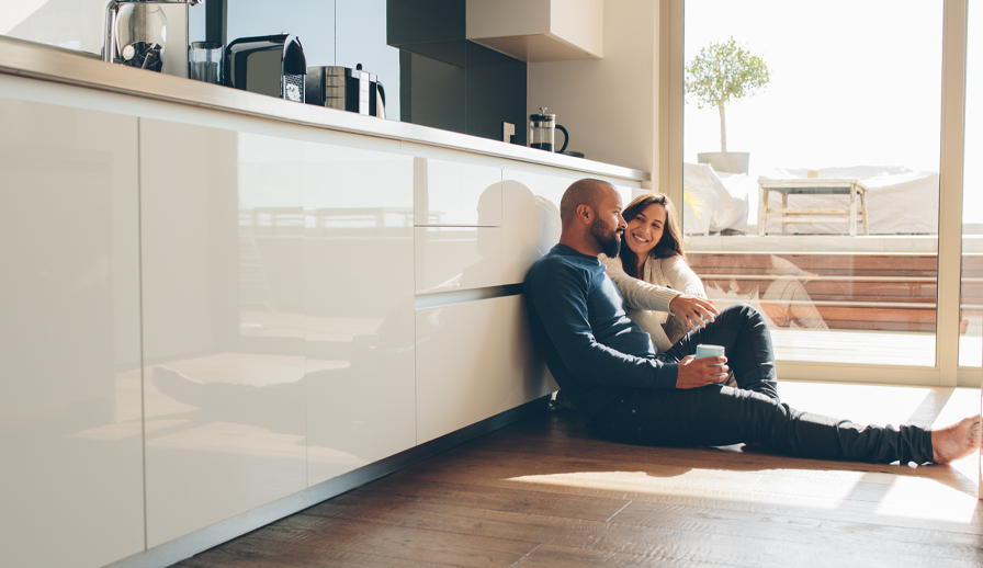 Young couple sits on the floor of their new home