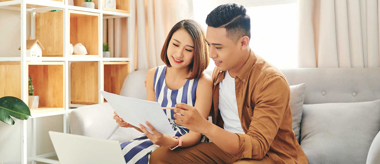 Happy couple looking at report