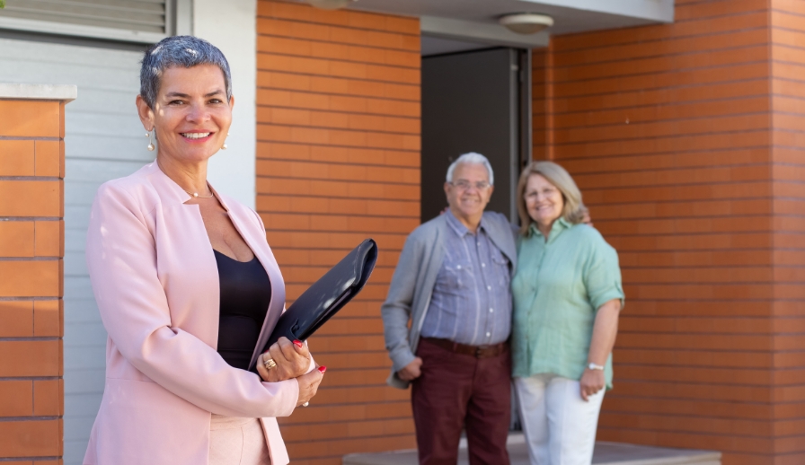 Real estate agent helping elderly couple