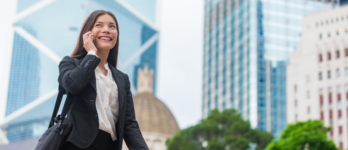 Woman on phone walking through urban area