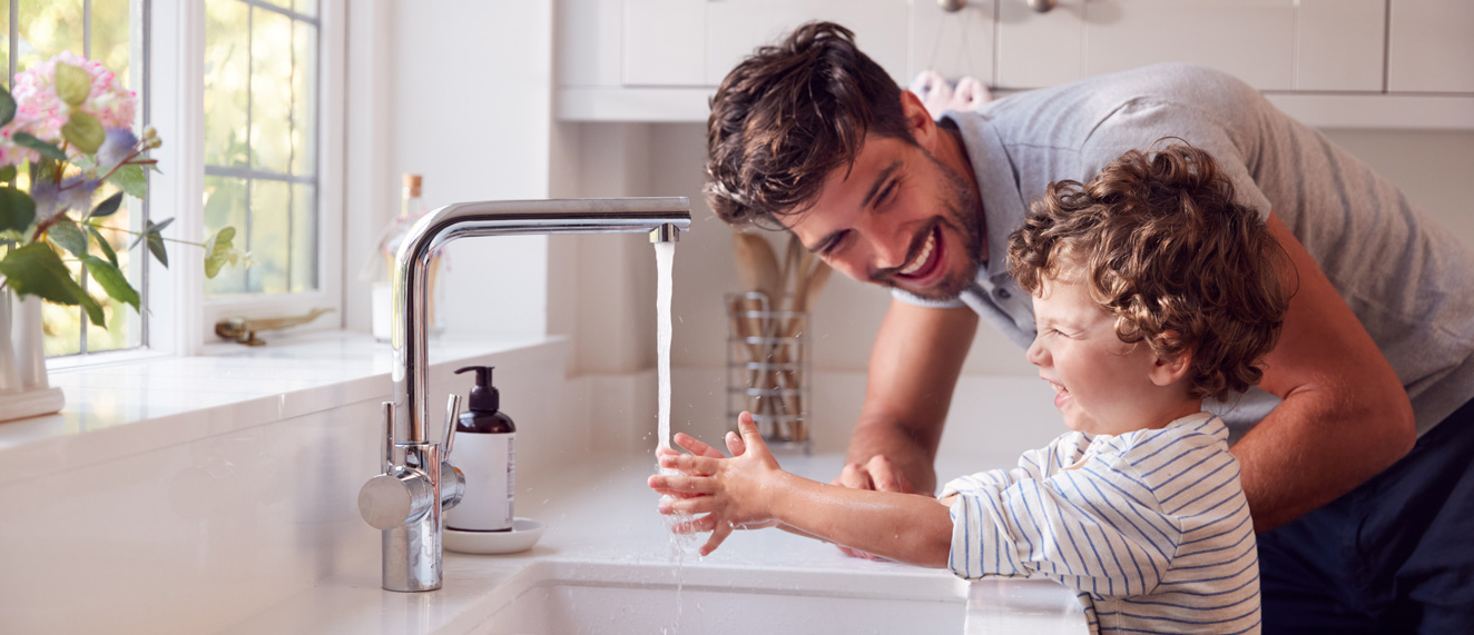 Dad washing child's hands