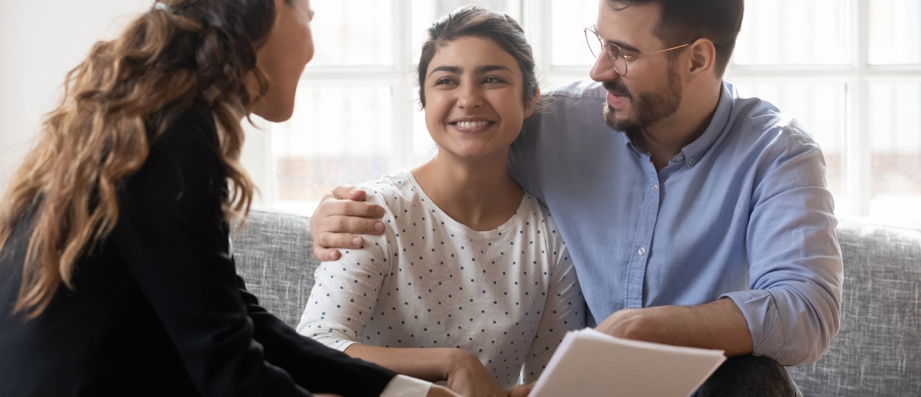 Couple talking to financial advisor.