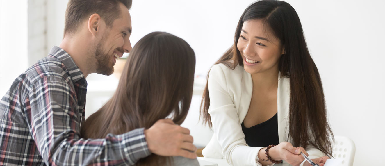 Female broker talking to clients.