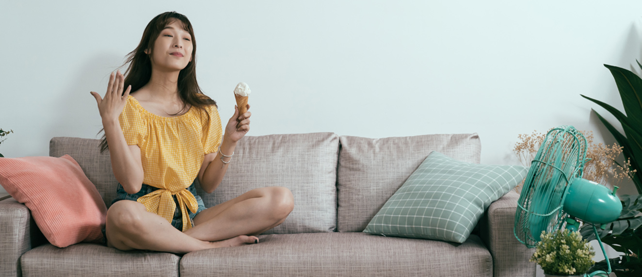 Woman sitting in front of fan.