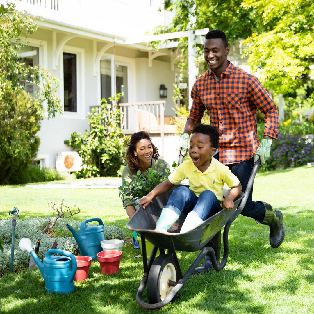 Family landscaping a yard