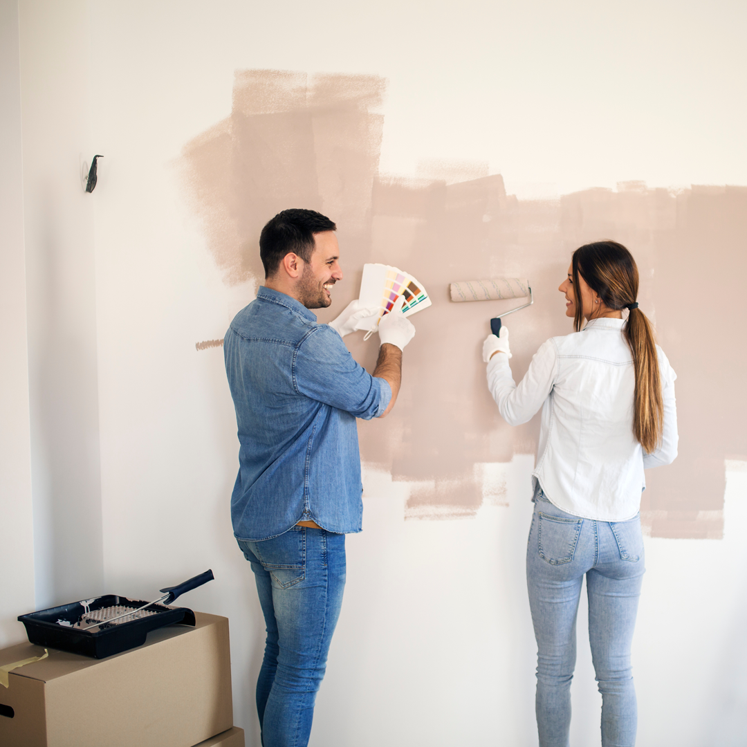 Couple applies a fresh coat of paint.