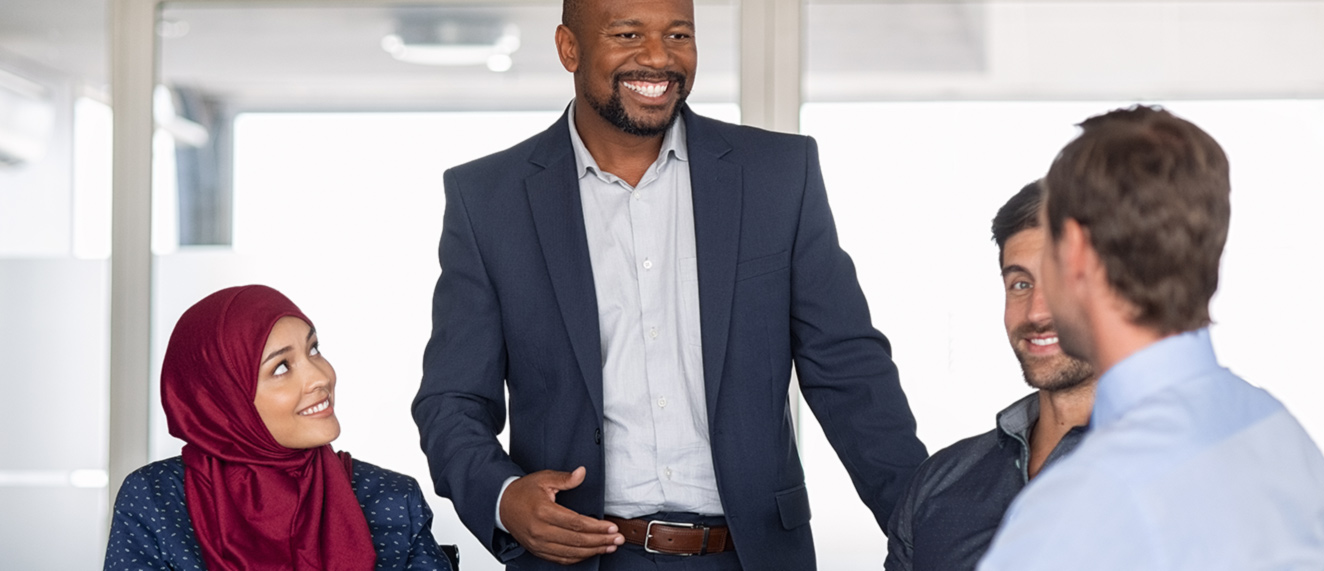 Male broker working with diverse coworkers.