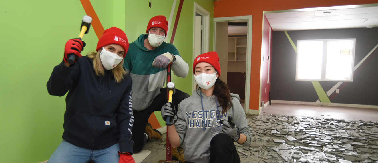 Volunteers from Winnipeg holder hammers.