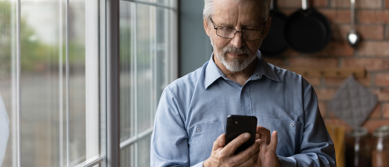 Man using his cellphone to learn about social media safety.