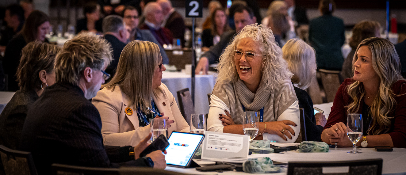 REALTORS® mingle at a table during CREA PAC 22.