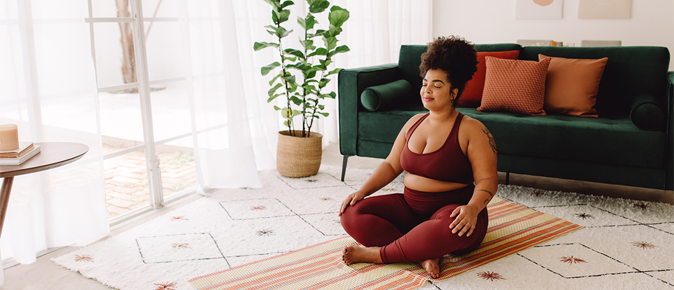 Healthy woman practicing yoga meditation at home