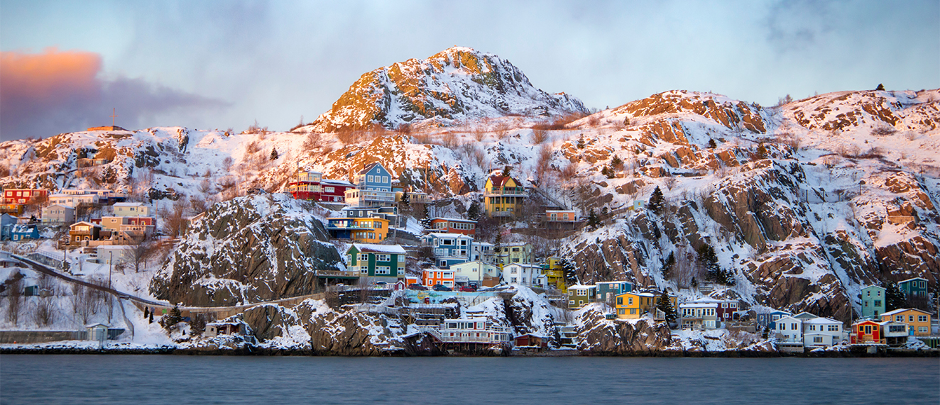 Oceanfront houses on the cliffside at sunset