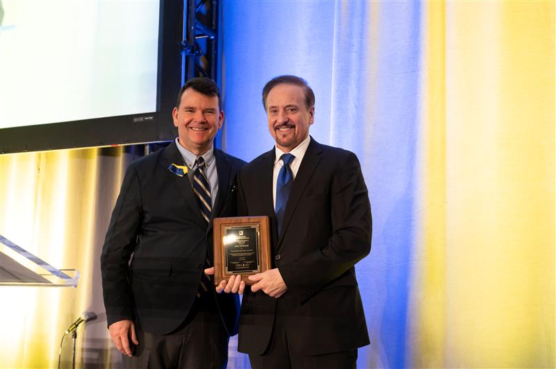 Michael Bourque presents John DiMichele with the AEN Award of Excellence.
