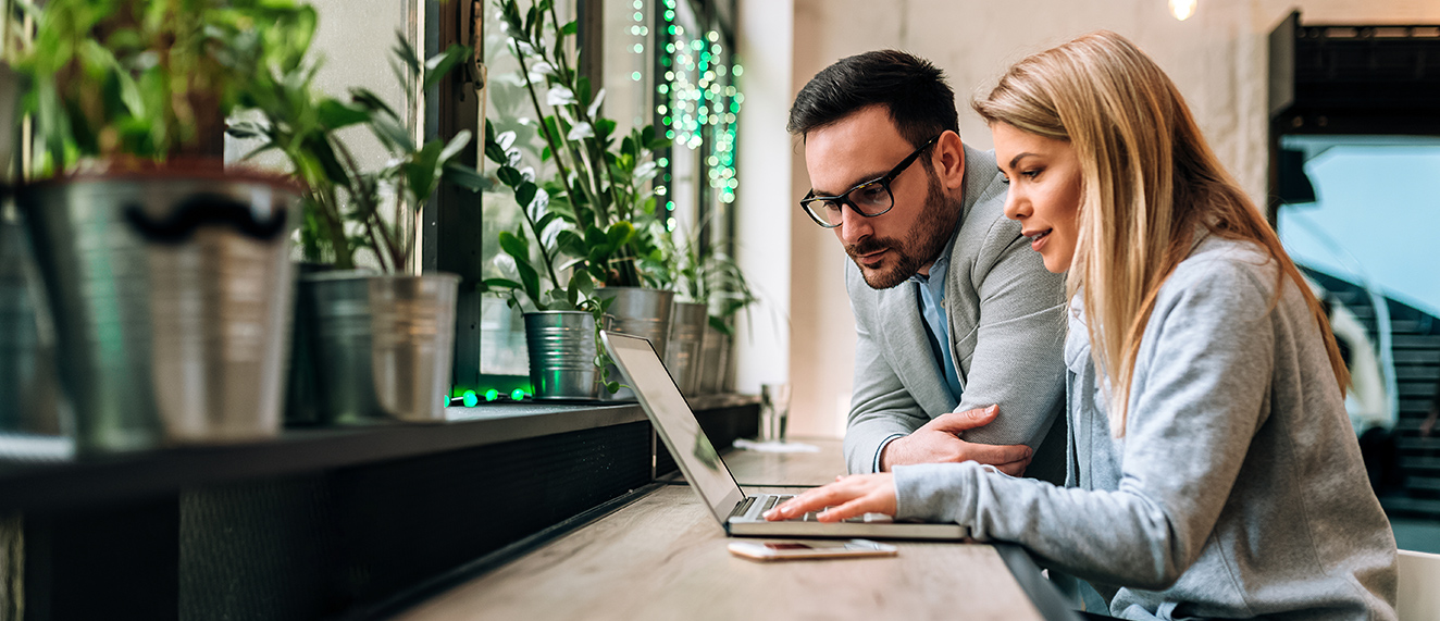 Couple looking at a laptop.