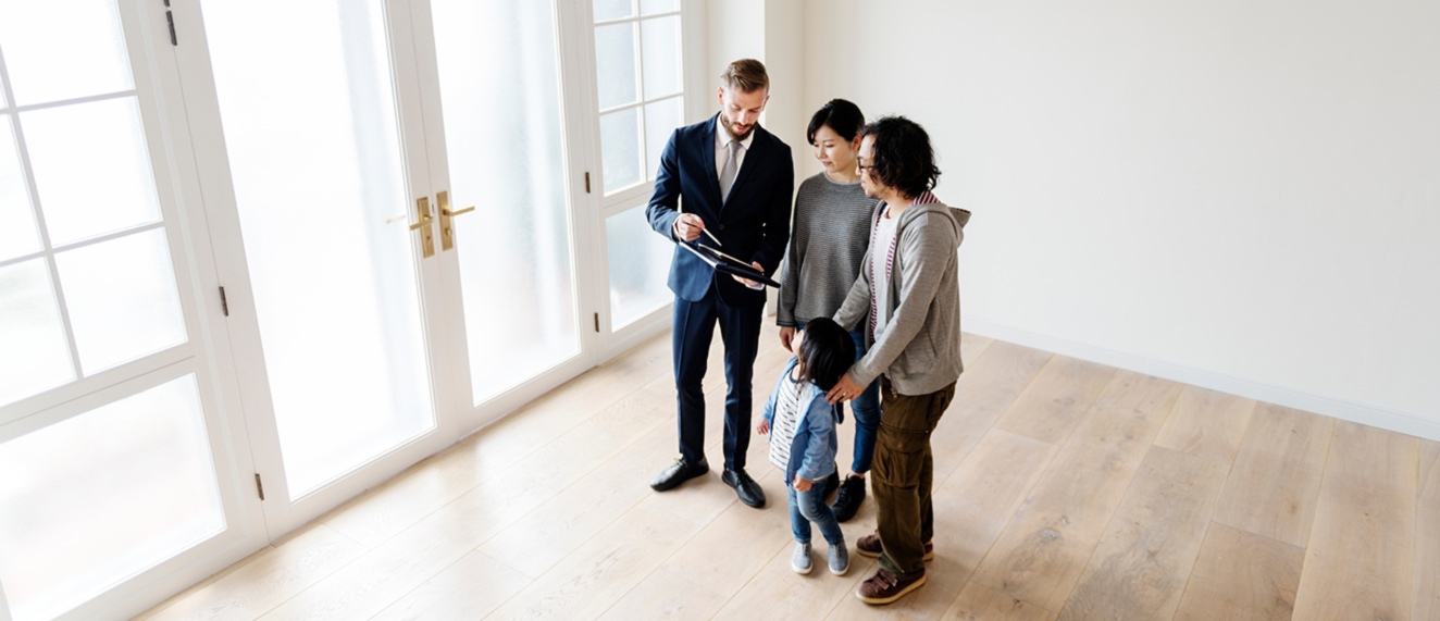 Couple in an empty house with a REALTOR(r).