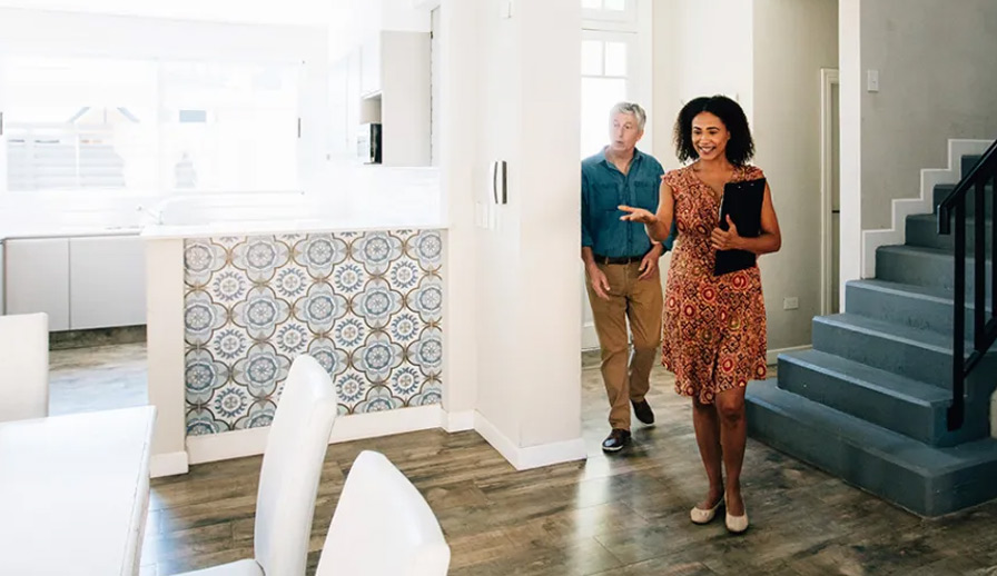 Woman showing man a house. 