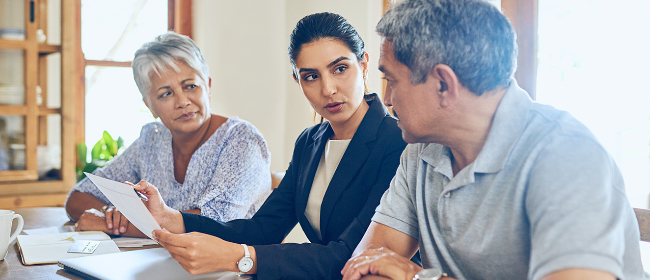 Couple sitting at table with a business woman.