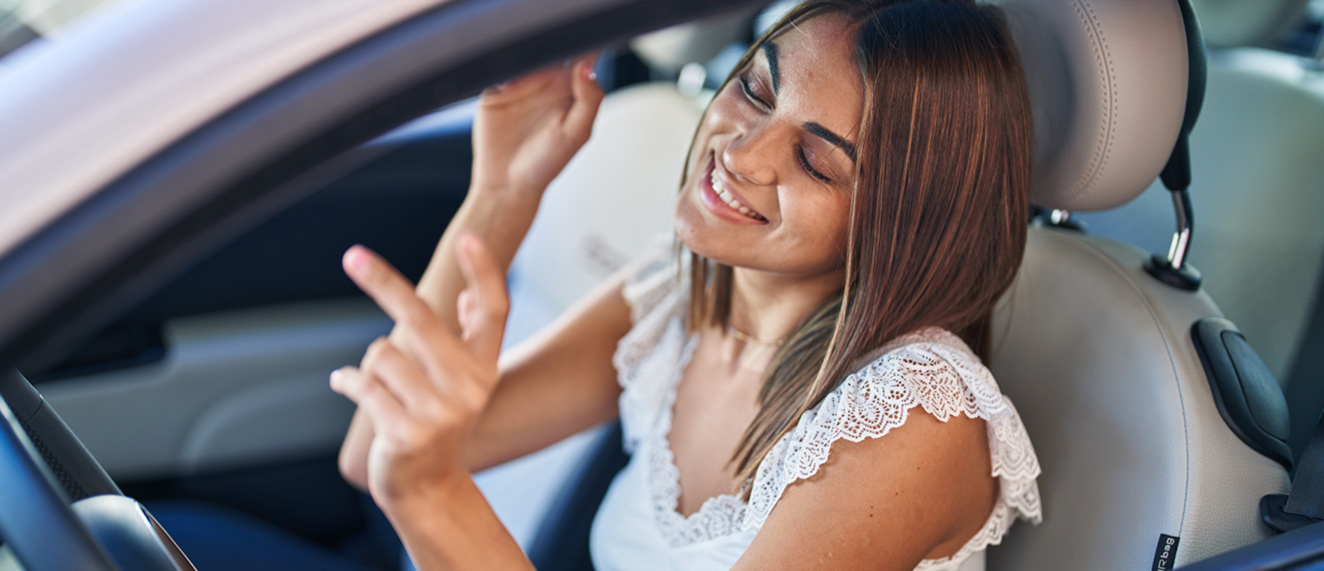 Woman listening to music in car.