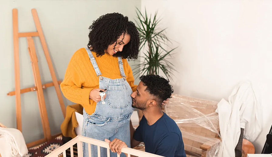 Man kissing belly of pregnant partner.