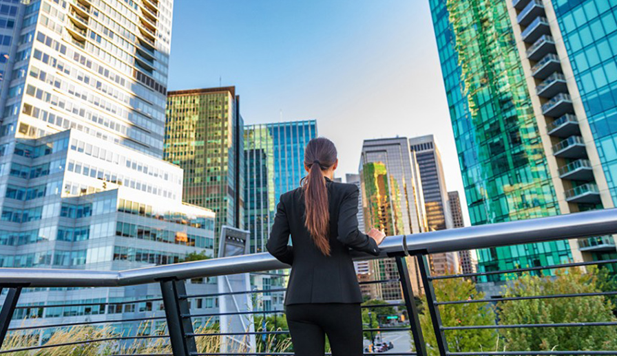 Female jogger looking at city skyline. 