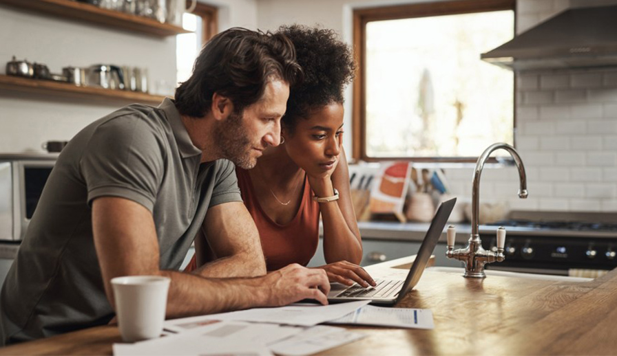 Couple looking at laptop. 