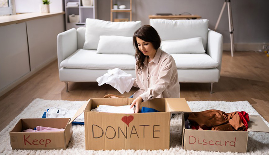 Woman putting items in a donate bin.