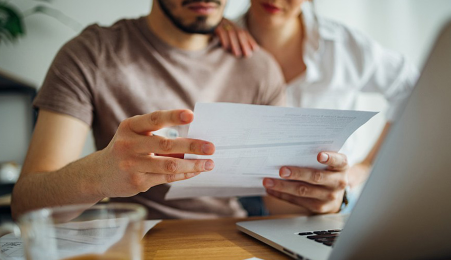 Couple looking at mail together. 