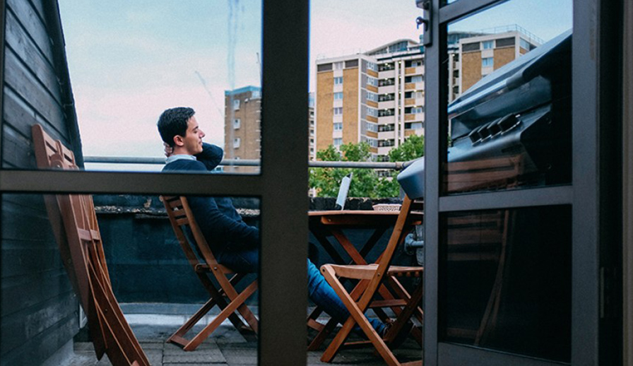 Man on phone on balcony. 