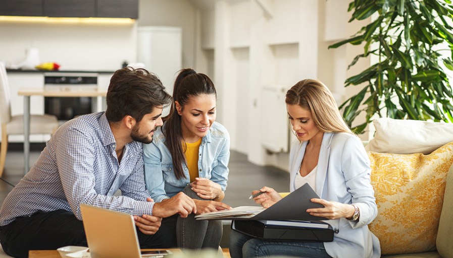 Couple speaking with real estate agent