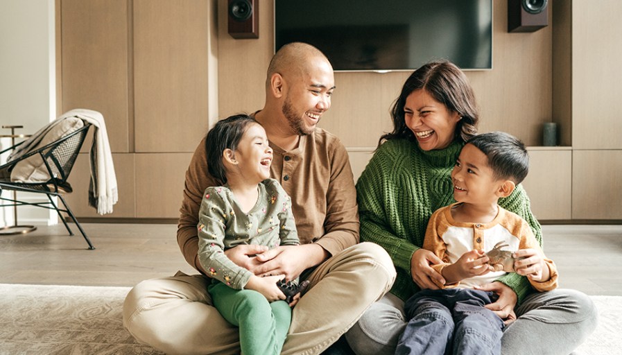 Family of four sitting together happy