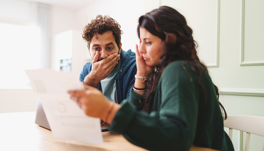 Couple reading documents together concerned