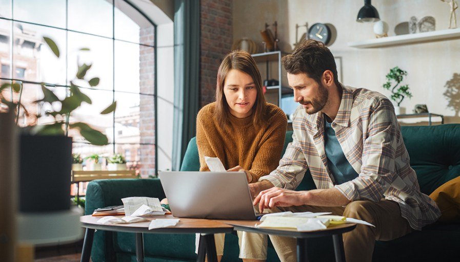 Couple looking at a laptop together. 